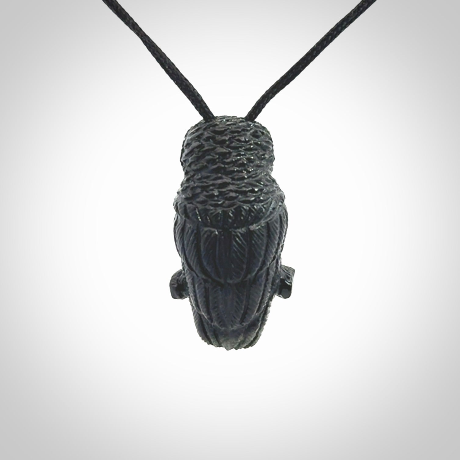 A traditional Owl design carving, hand made for us from Australian Black Jade. This is a work of art and is a collectable piece of traditional Black Jade carving. It can be worn as a special piece of jewellery or displayed. This is art made to wear at its finest. A unisex pendant for owl lovers. This pendant is provided with an adjustable cord.
