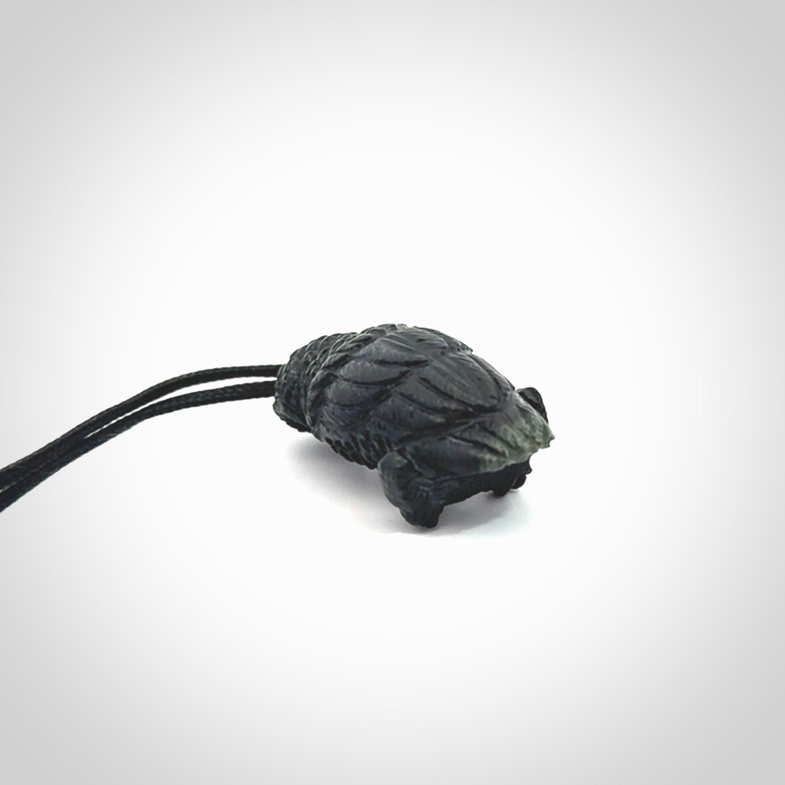 A traditional Owl design carving, hand made for us from Australian Black Jade. This is a work of art and is a collectable piece of traditional Black Jade carving. It can be worn as a special piece of jewellery or displayed. This is art made to wear at its finest. A unisex pendant for owl lovers. This pendant is provided with an adjustable cord.