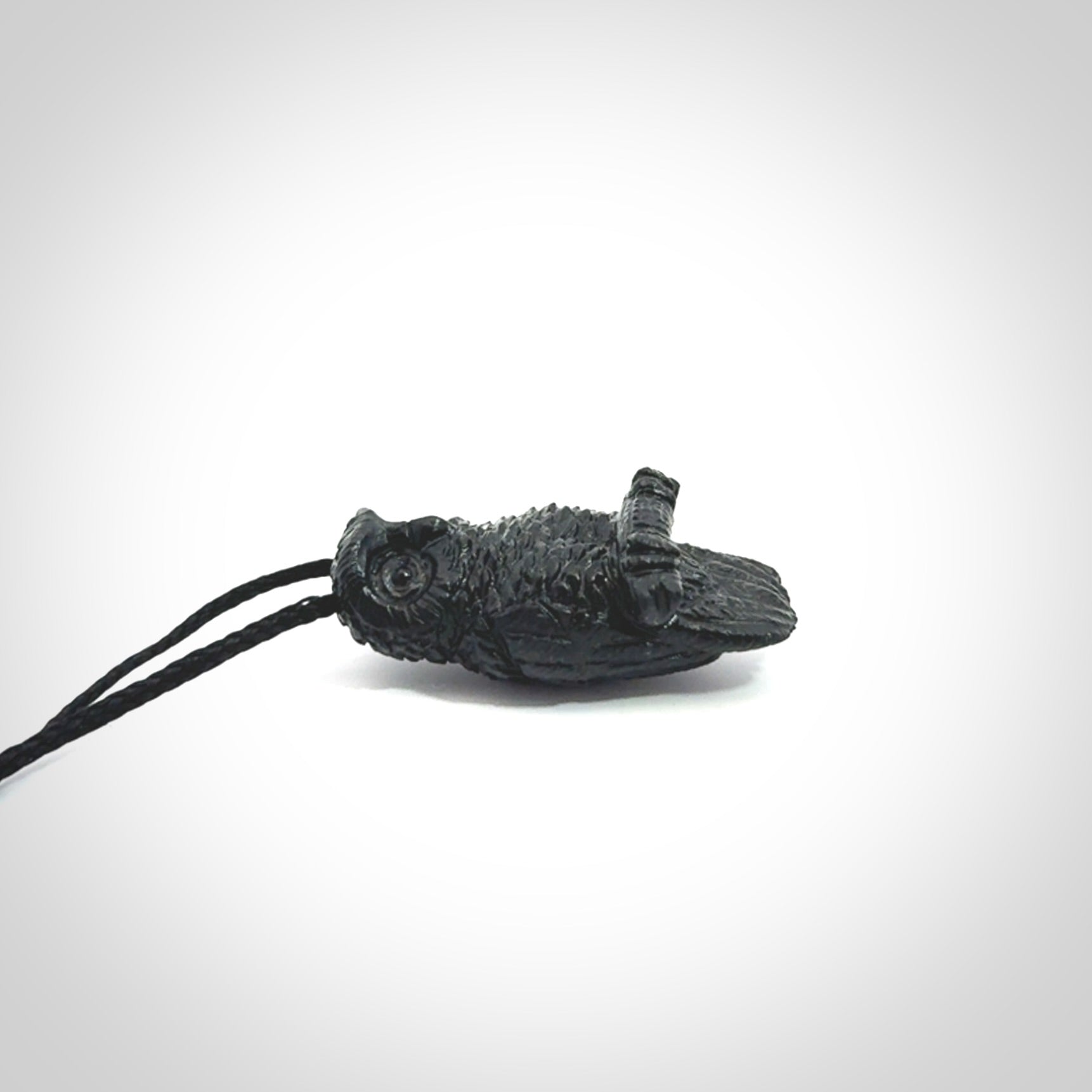 A traditional Owl design carving, hand made for us from Australian Black Jade. This is a work of art and is a collectable piece of traditional Black Jade carving. It can be worn as a special piece of jewellery or displayed. This is art made to wear at its finest. A unisex pendant for owl lovers. This pendant is provided with an adjustable cord.