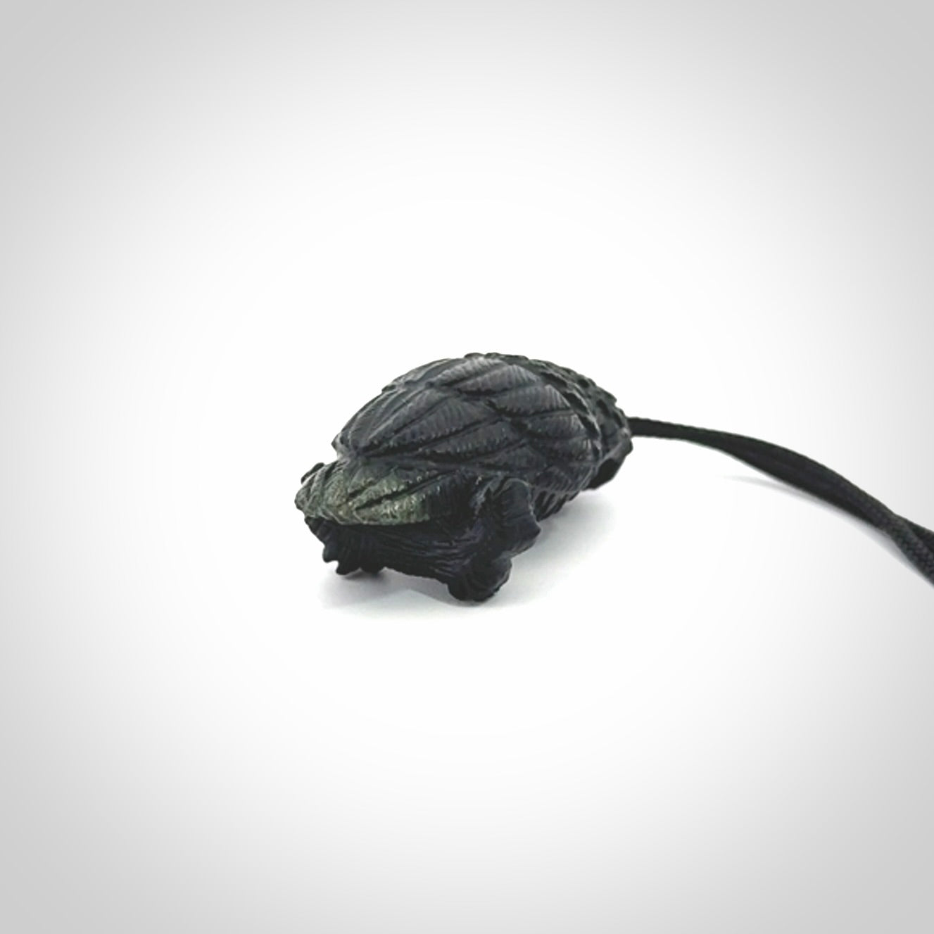 A traditional Owl design carving, hand made for us from Australian Black Jade. This is a work of art and is a collectable piece of traditional Black Jade carving. It can be worn as a special piece of jewellery or displayed. This is art made to wear at its finest. A unisex pendant for owl lovers. This pendant is provided with an adjustable cord.