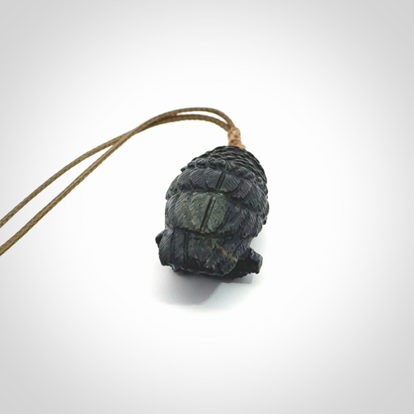 A traditional Owl design carving, hand made for us from Australian Black Jade. This is a work of art and is a collectable piece of traditional Black Jade carving. It can be worn as a special piece of jewellery or displayed. This is art made to wear at its finest. A unisex pendant for owl lovers. This pendant is provided with an adjustable cord.