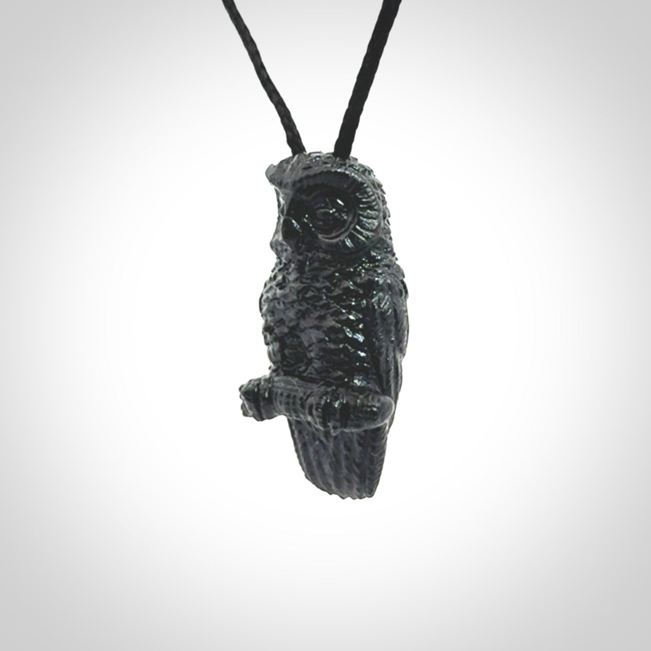 A traditional Owl design carving, hand made for us from Australian Black Jade. This is a work of art and is a collectable piece of traditional Black Jade carving. It can be worn as a special piece of jewellery or displayed. This is art made to wear at its finest. A unisex pendant for owl lovers. This pendant is provided with an adjustable cord.