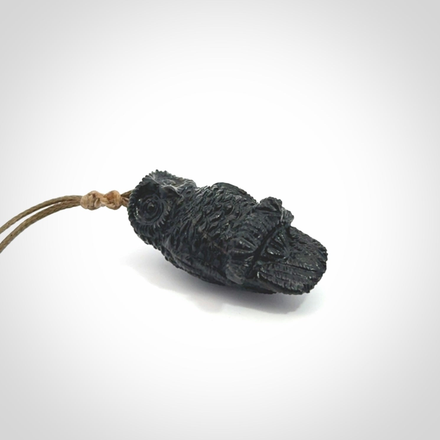 A traditional Owl design carving, hand made for us from Australian Black Jade. This is a work of art and is a collectable piece of traditional Black Jade carving. It can be worn as a special piece of jewellery or displayed. This is art made to wear at its finest. A unisex pendant for owl lovers. This pendant is provided with an adjustable cord.
