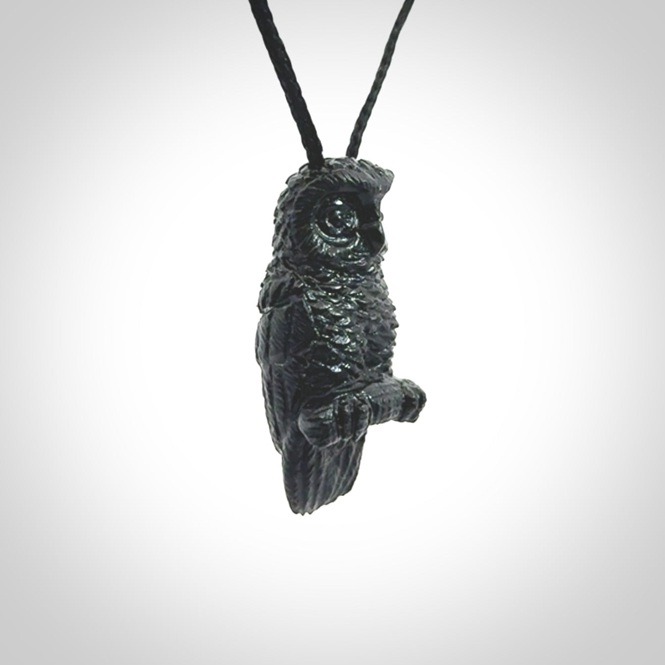A traditional Owl design carving, hand made for us from Australian Black Jade. This is a work of art and is a collectable piece of traditional Black Jade carving. It can be worn as a special piece of jewellery or displayed. This is art made to wear at its finest. A unisex pendant for owl lovers. This pendant is provided with an adjustable cord.