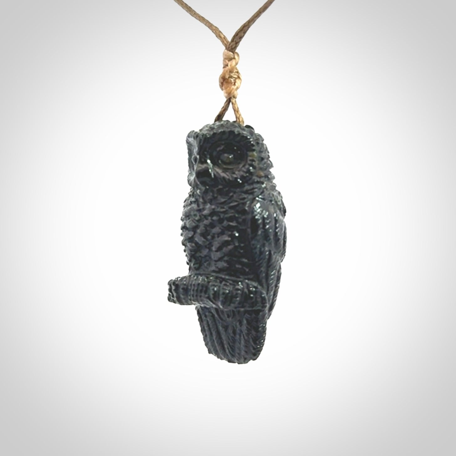 A traditional Owl design carving, hand made for us from Australian Black Jade. This is a work of art and is a collectable piece of traditional Black Jade carving. It can be worn as a special piece of jewellery or displayed. This is art made to wear at its finest. A unisex pendant for owl lovers. This pendant is provided with an adjustable cord.