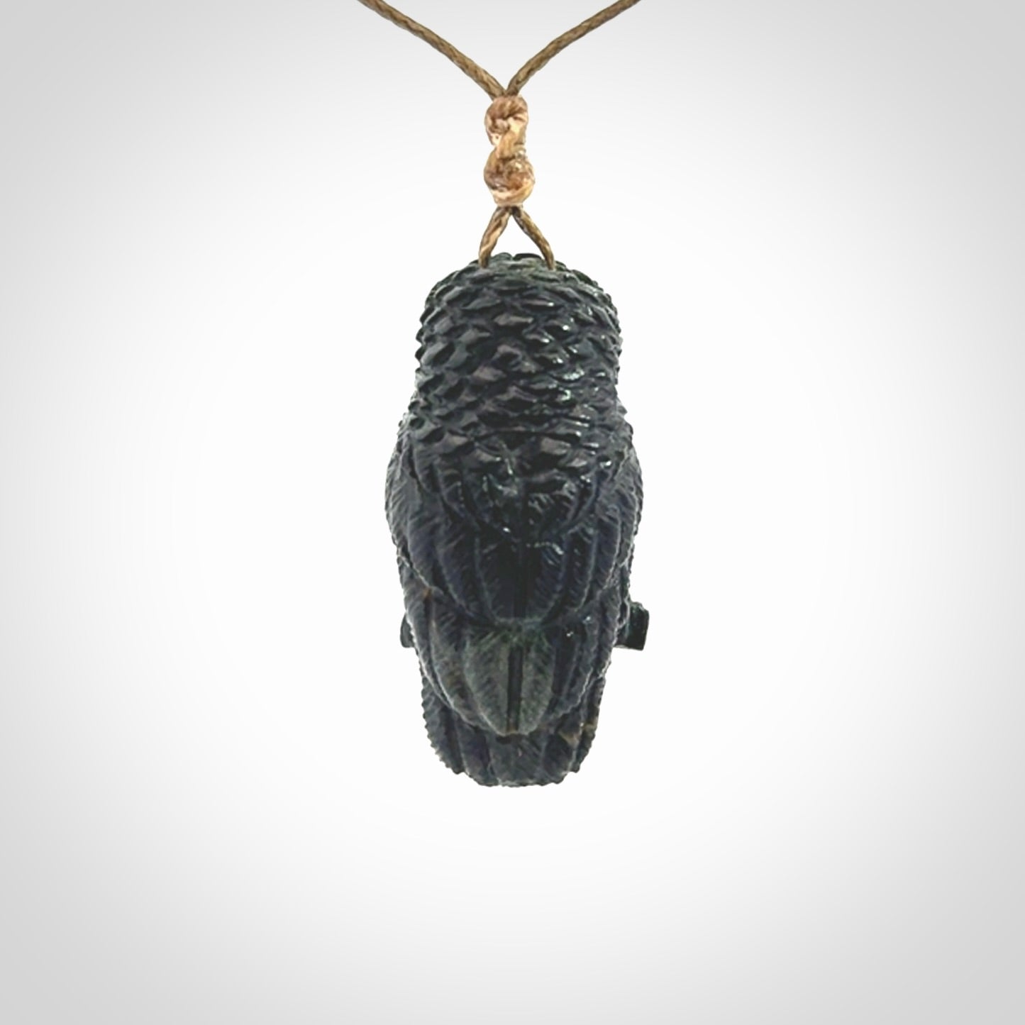 A traditional Owl design carving, hand made for us from Australian Black Jade. This is a work of art and is a collectable piece of traditional Black Jade carving. It can be worn as a special piece of jewellery or displayed. This is art made to wear at its finest. A unisex pendant for owl lovers. This pendant is provided with an adjustable cord.