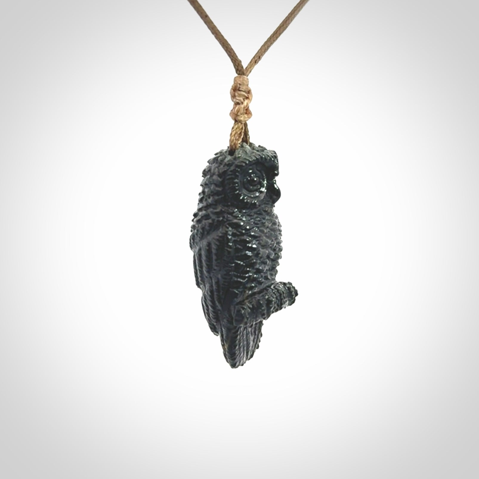 A traditional Owl design carving, hand made for us from Australian Black Jade. This is a work of art and is a collectable piece of traditional Black Jade carving. It can be worn as a special piece of jewellery or displayed. This is art made to wear at its finest. A unisex pendant for owl lovers. This pendant is provided with an adjustable cord.