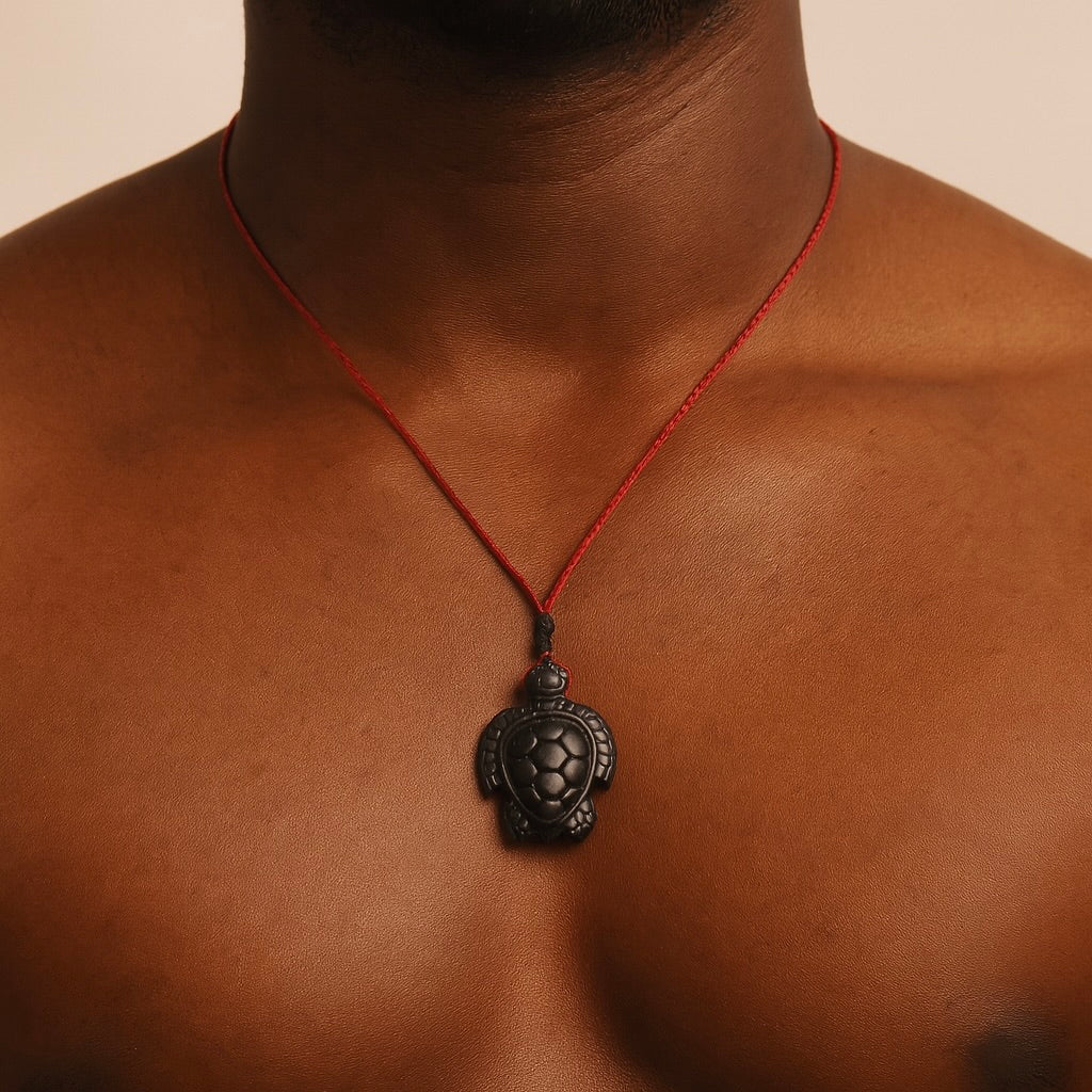 This picture shows a hand carved black jade turtle pendant being worn.