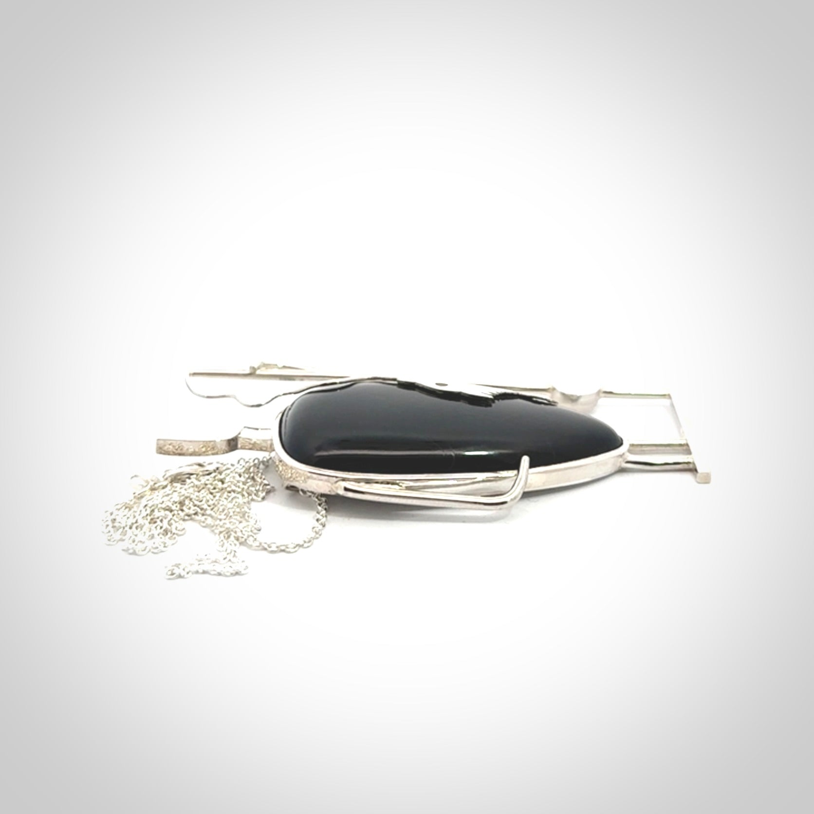 This is a very cool and creative fisherman hand made from Australian Black Jade and Sterling Silver. A fisherman who had caught a fish pendant hand crafted from sterling silver with Black Jade torso. A spectacular piece of art to wear with sterling silver chain.