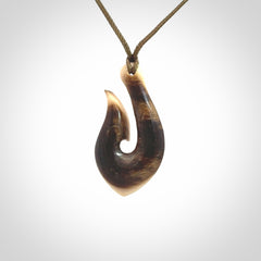A fish hook necklace (hei-matau) hand-carved in a traditional style from Woolly Mammoth Tusk. These are glorious pieces of art to wear. Provided with adjustable cords and packaged in a woven kete pouch. Delivered with express courier.