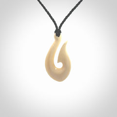 A fish hook necklace (hei-matau) hand-carved in a traditional style from Woolly Mammoth Tusk. These are glorious pieces of art to wear. Provided with adjustable cords and packaged in a woven kete pouch. Delivered with express courier.