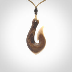 A fish hook necklace (hei-matau) hand-carved in a traditional style from Woolly Mammoth Tusk. These are glorious pieces of art to wear. Provided with adjustable cords and packaged in a woven kete pouch. Delivered with express courier.
