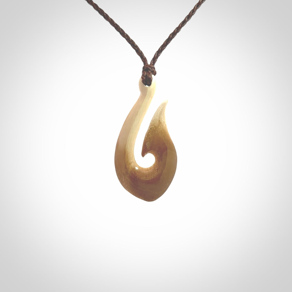 A fish hook necklace (hei-matau) hand-carved in a traditional style from Woolly Mammoth Tusk. These are glorious pieces of art to wear. Provided with adjustable cords and packaged in a woven kete pouch. Delivered with express courier.