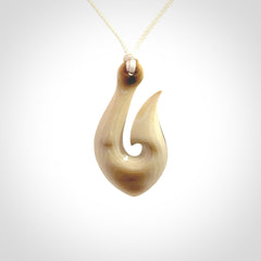 A fish hook necklace (hei-matau) hand-carved in a traditional style from Woolly Mammoth Tusk. These are glorious pieces of art to wear. Provided with adjustable cords and packaged in a woven kete pouch. Delivered with express courier.