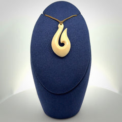A fish hook necklace (hei-matau) hand-carved in a traditional style from Woolly Mammoth Tusk. These are glorious pieces of art to wear. Provided with adjustable cords and packaged in a woven kete pouch