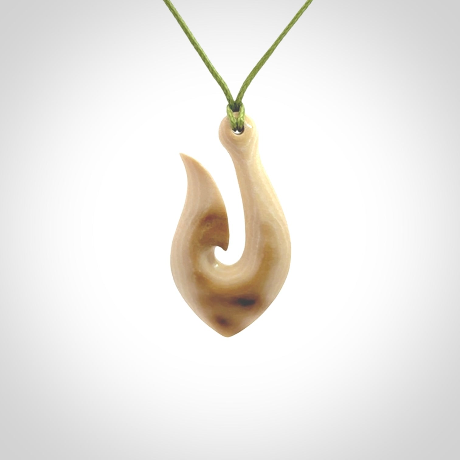 A fish hook necklace (hei-matau) hand-carved in a traditional style from Woolly Mammoth Tusk. These are glorious pieces of art to wear. Provided with adjustable cords and packaged in a woven kete pouch. Delivered with express courier.