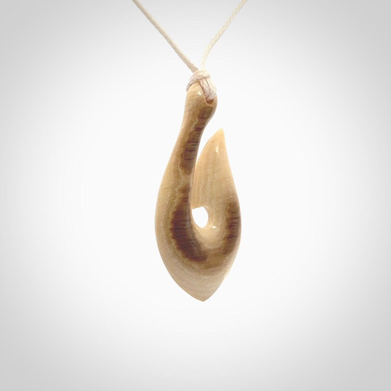 A fish hook necklace (hei-matau) hand-carved in a traditional style from Woolly Mammoth Tusk. These are glorious pieces of art to wear. Provided with adjustable cords and packaged in a woven kete pouch. Delivered with express courier.