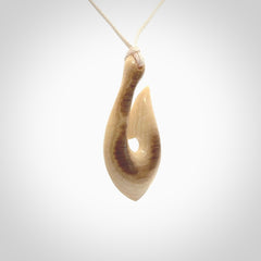 A fish hook necklace (hei-matau) hand-carved in a traditional style from Woolly Mammoth Tusk. These are glorious pieces of art to wear. Provided with adjustable cords and packaged in a woven kete pouch. Delivered with express courier.