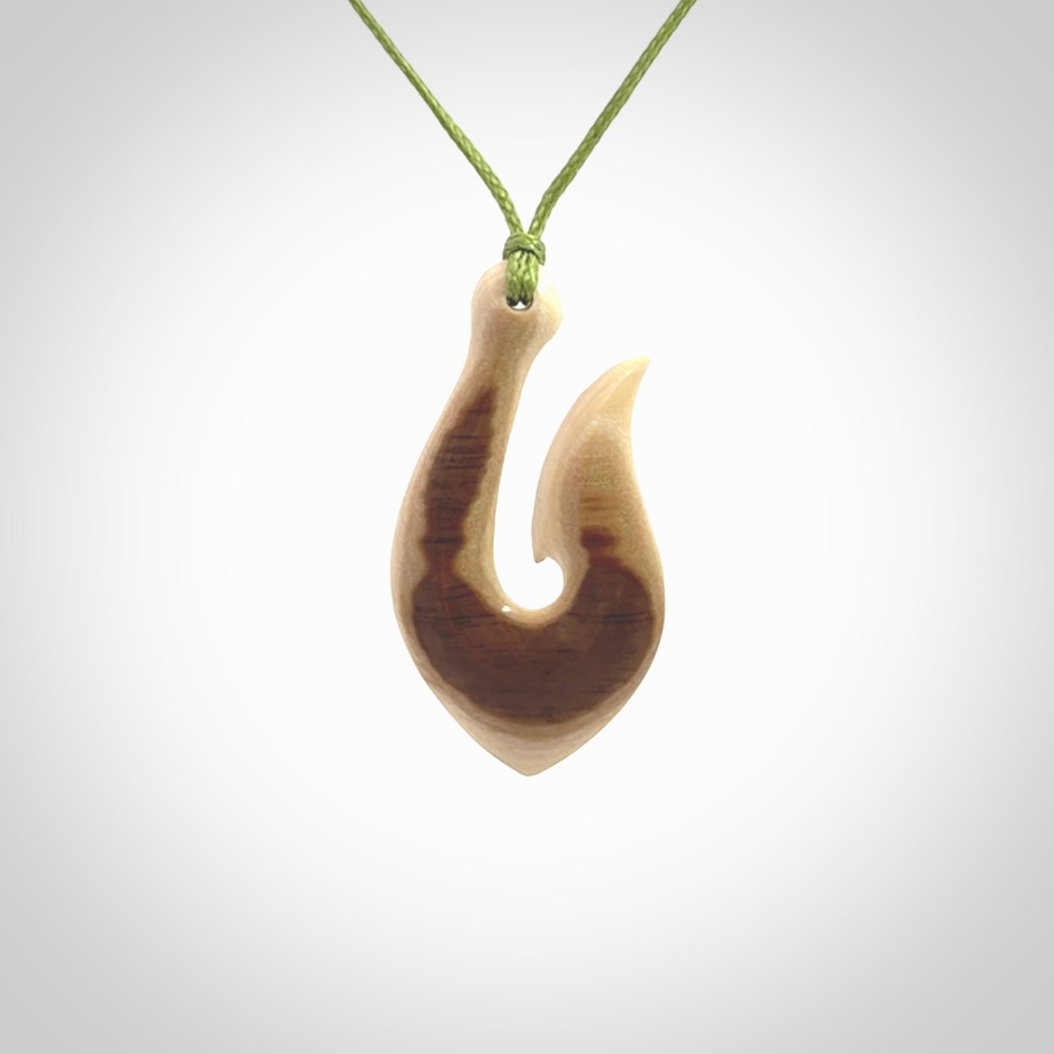 A fish hook necklace (hei-matau) hand-carved in a traditional style from Woolly Mammoth Tusk. These are glorious pieces of art to wear. Provided with adjustable cords and packaged in a woven kete pouch. Delivered with express courier.