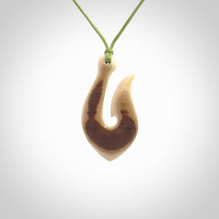 A fish hook necklace (hei-matau) hand-carved in a traditional style from Woolly Mammoth Tusk. These are glorious pieces of art to wear. Provided with adjustable cords and packaged in a woven kete pouch. Delivered with express courier.