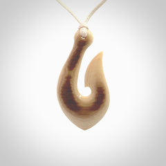 A fish hook necklace (hei-matau) hand-carved in a traditional style from Woolly Mammoth Tusk. These are glorious pieces of art to wear. Provided with adjustable cords and packaged in a woven kete pouch. Delivered with express courier.