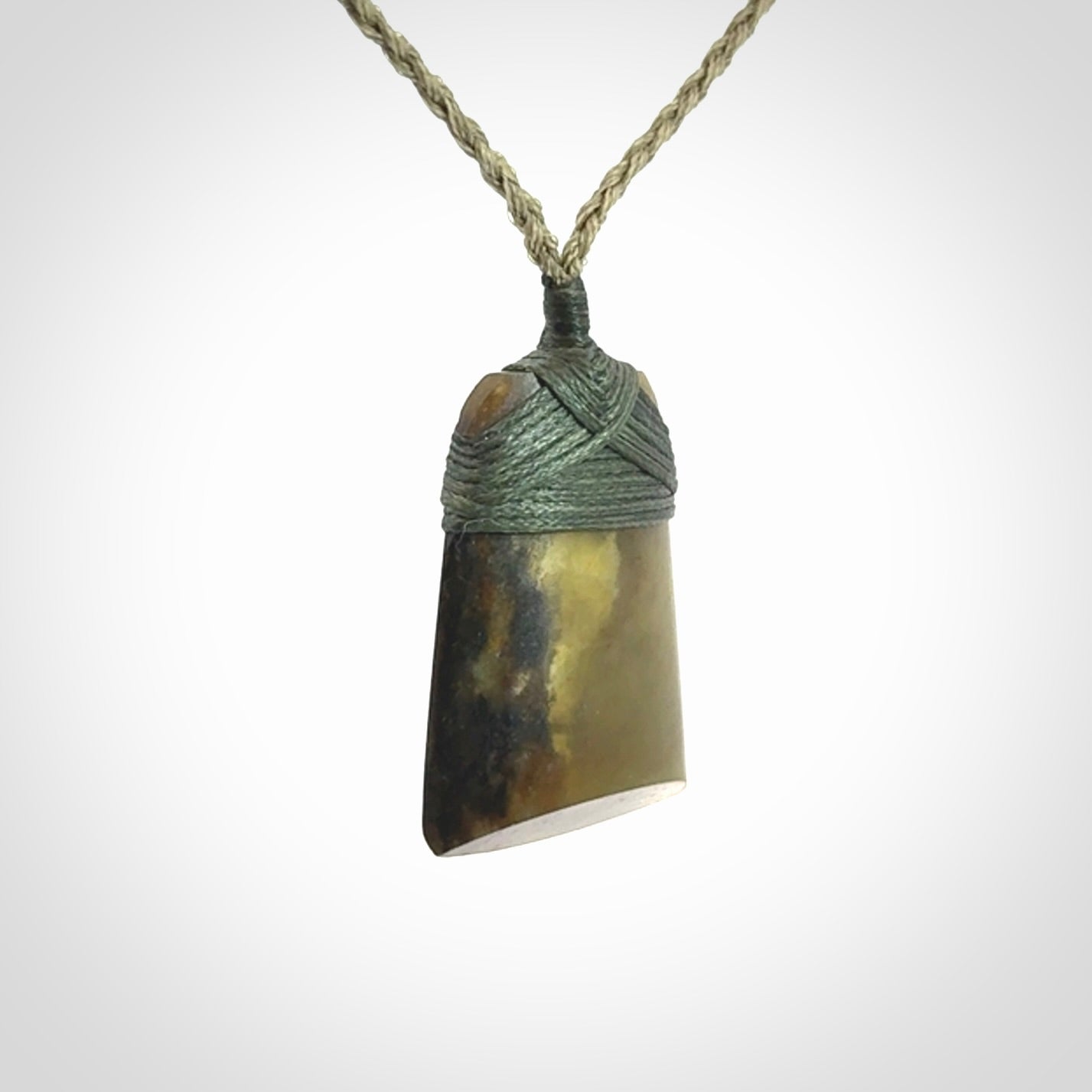 Hand carved toki pendant in a mysterious and beautiful piece of jade