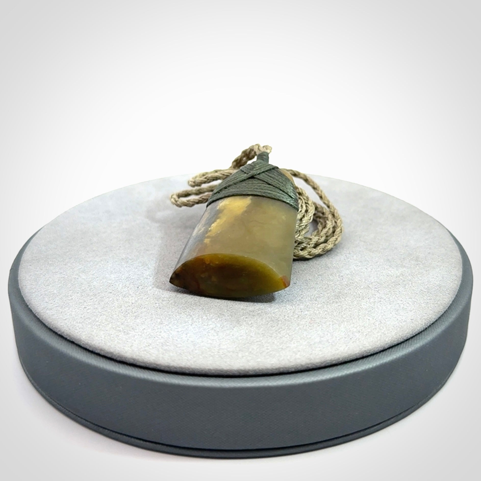 Hand carved toki pendant in a mysterious and beautiful piece of jade