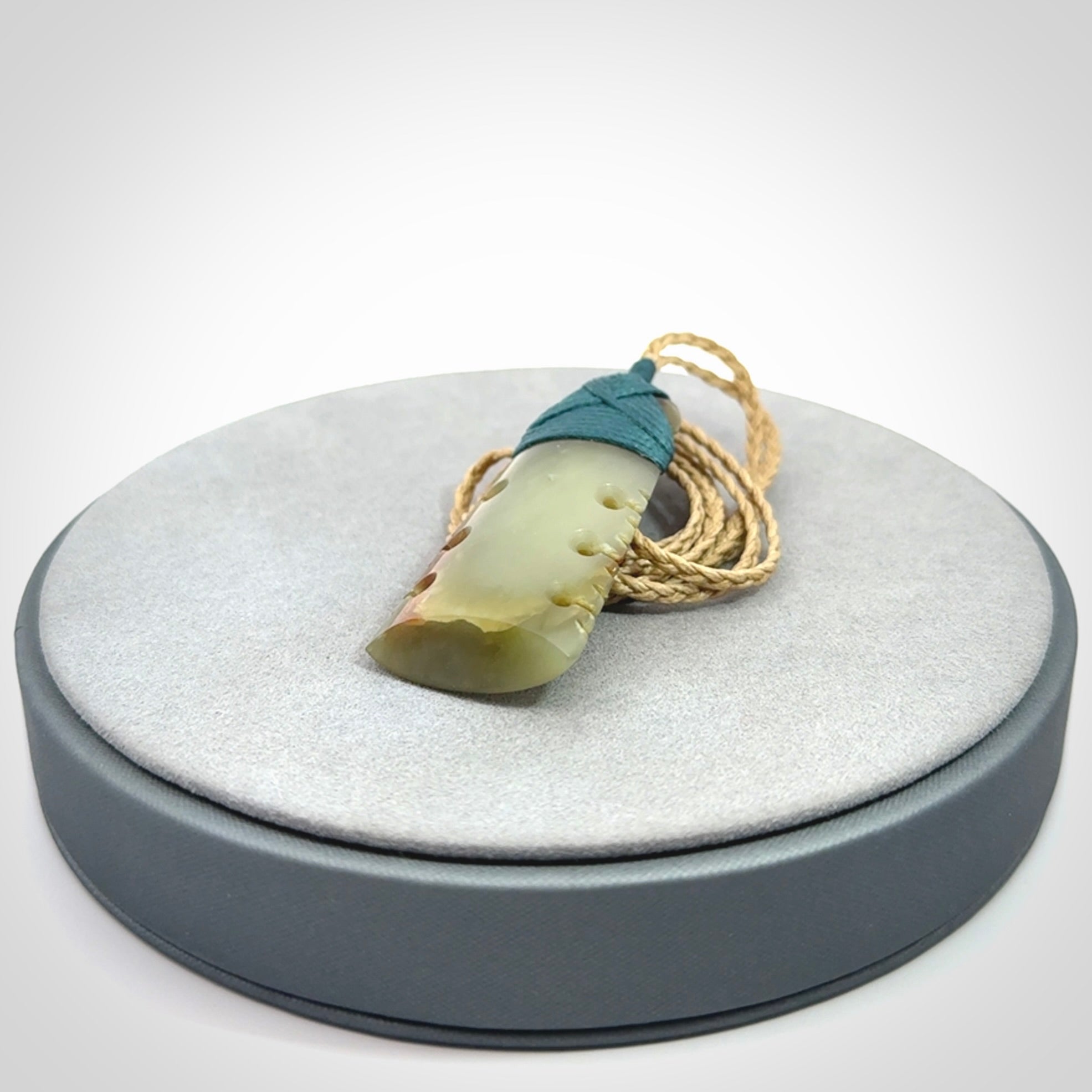 A beautiful, notched, New Zealand jade toki pendant