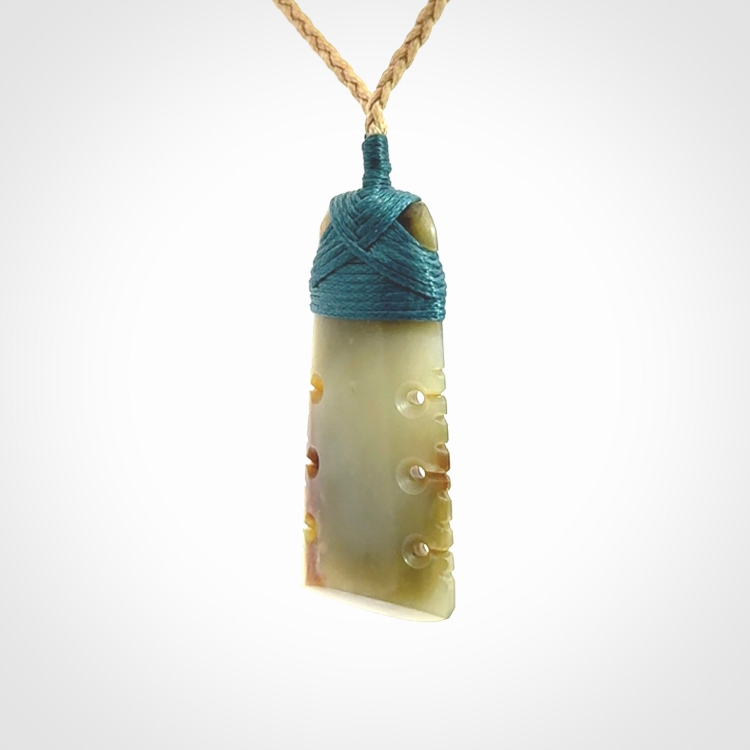 A beautiful, notched, New Zealand jade toki pendant