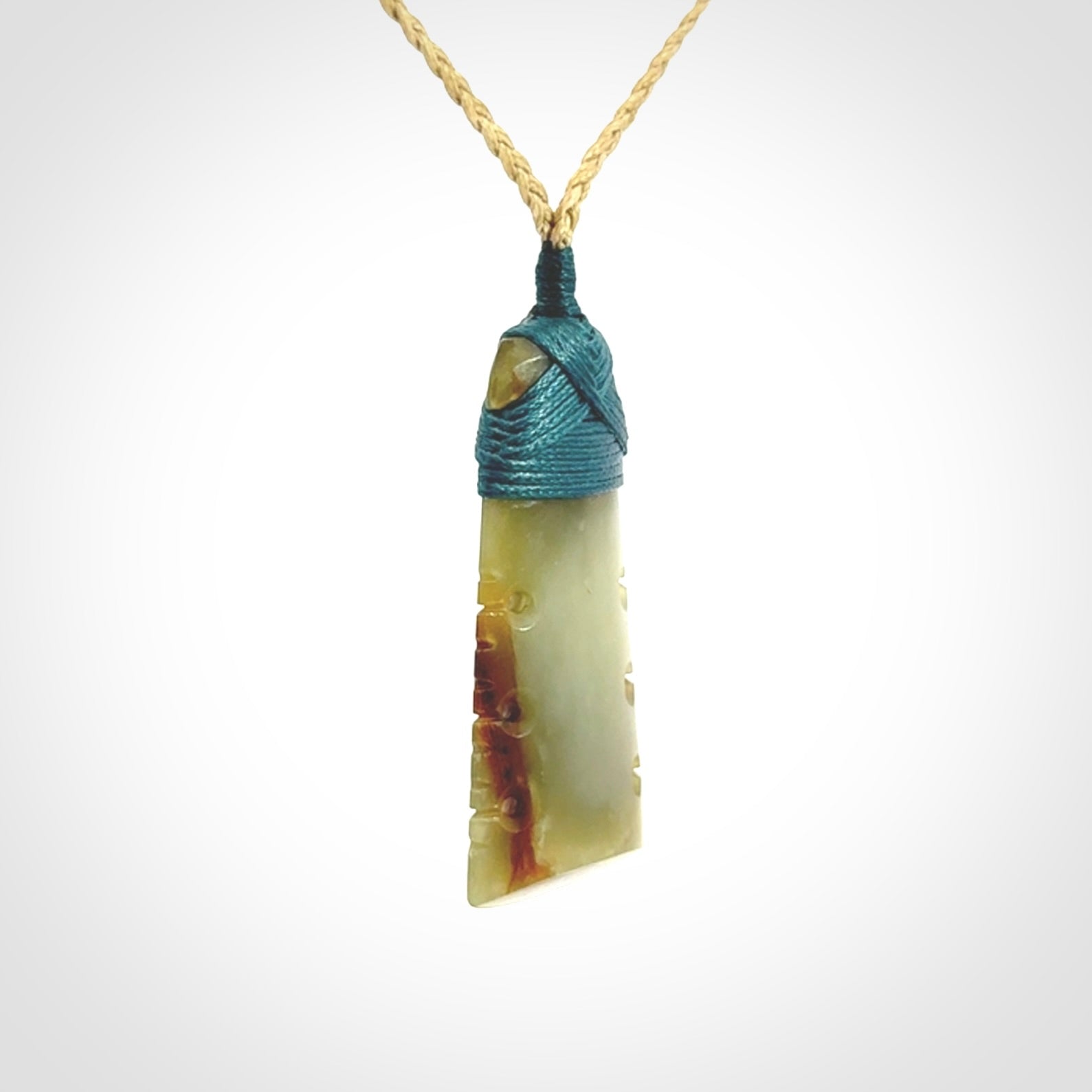 A beautiful, notched, New Zealand jade toki pendant