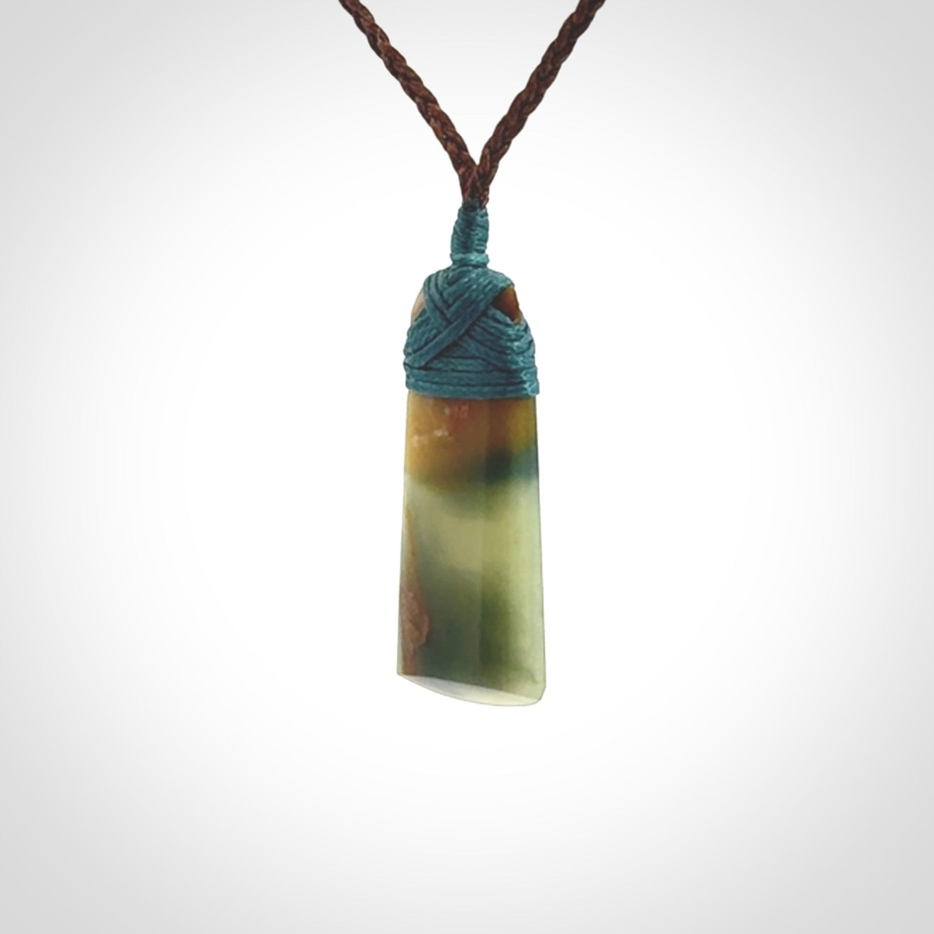 A beautiful, small, New Zealand jade toki pendant