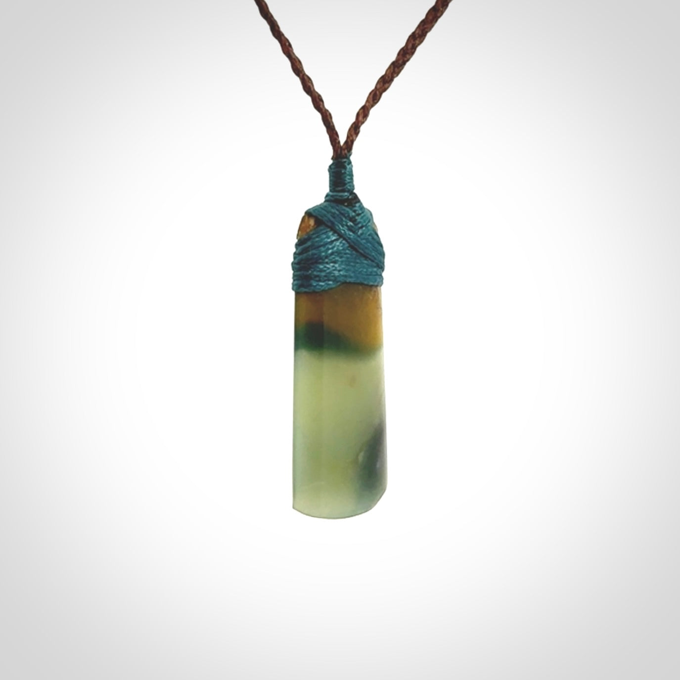 A beautiful, small, New Zealand jade toki pendant