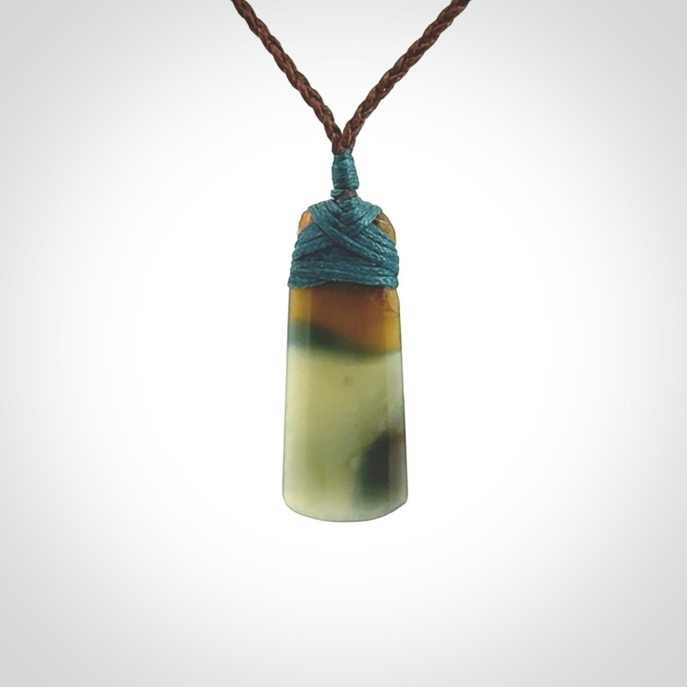 A beautiful, small, New Zealand jade toki pendant