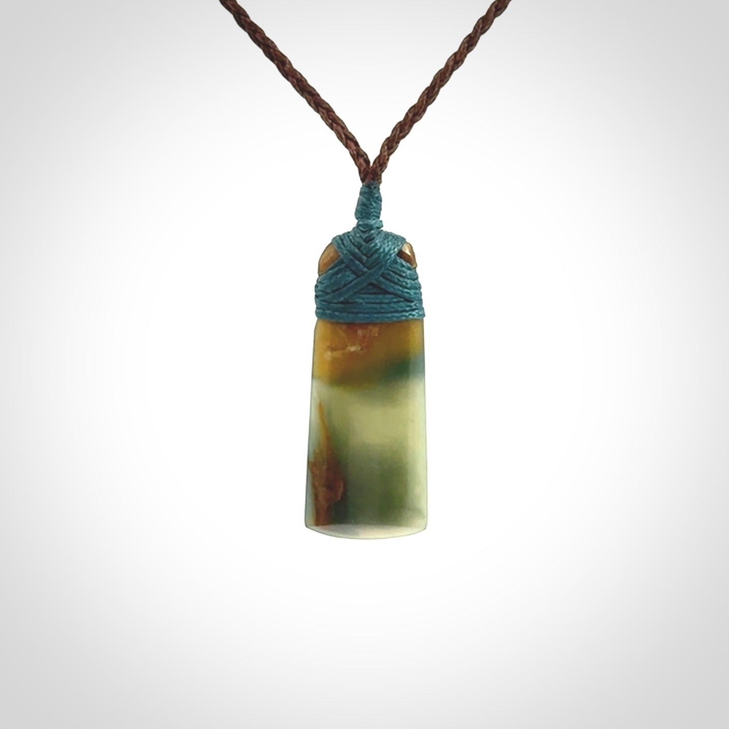 A beautiful, small, New Zealand jade toki pendant