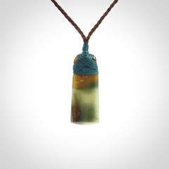 A beautiful, small, New Zealand jade toki pendant