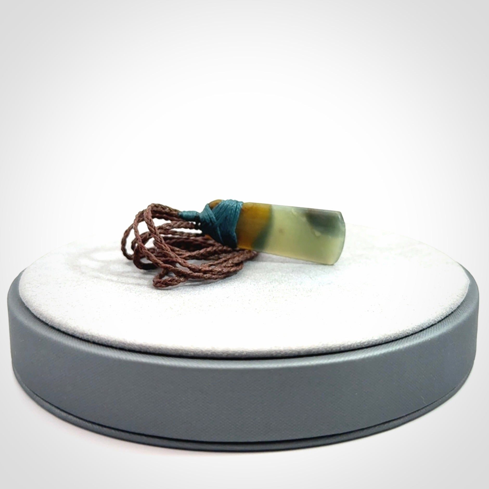A beautiful, small, New Zealand jade toki pendant