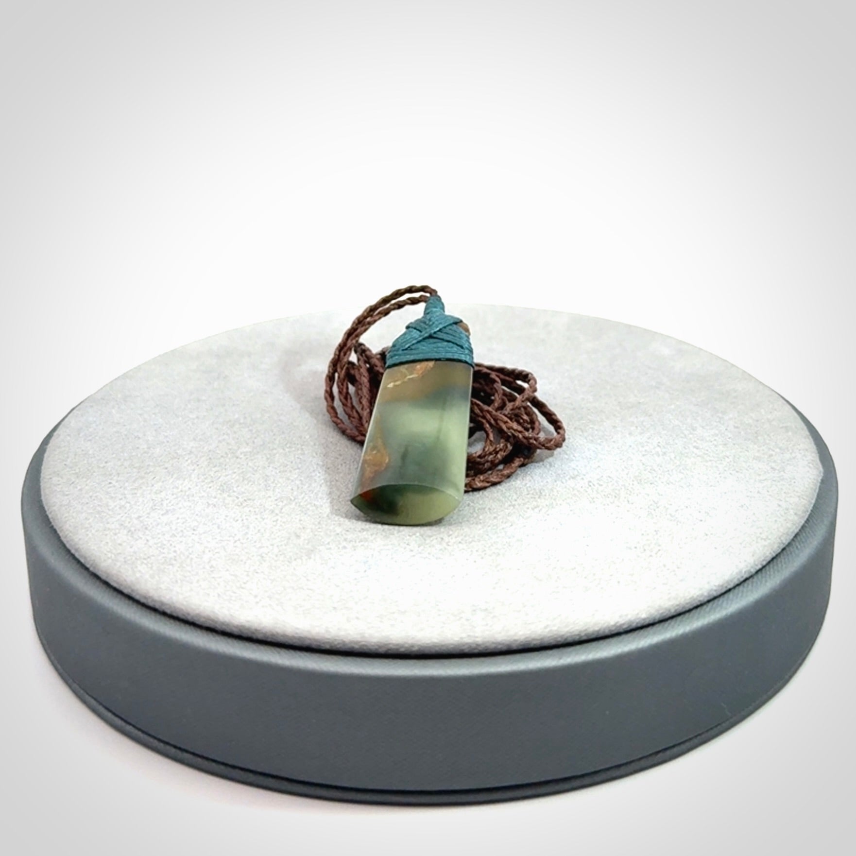 A beautiful, small, New Zealand jade toki pendant