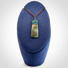 A beautiful, small, New Zealand jade toki pendant