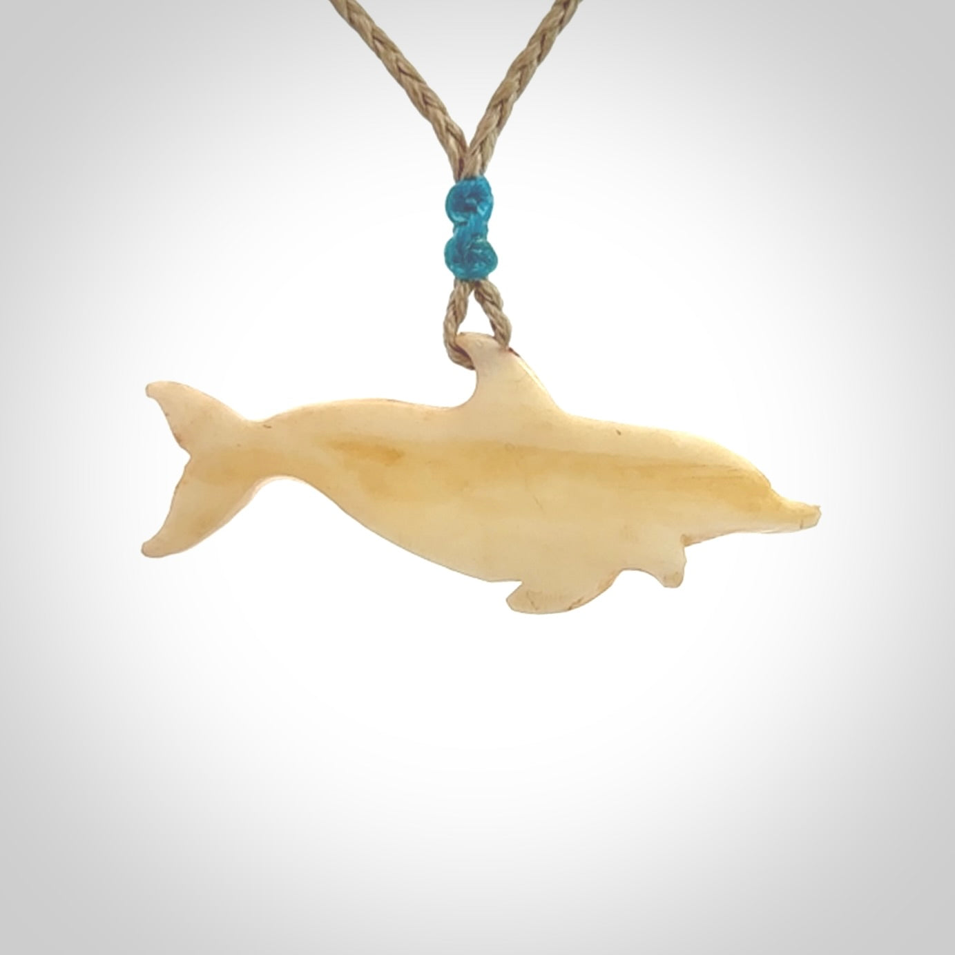 Hand carved dolphin bone pendant. Hand made bone dolphin necklace. Hand crafted bone dolphin pendant. Provided with an adjustable cord.