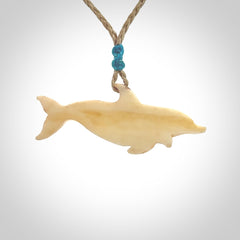 Hand carved dolphin bone pendant. Hand made bone dolphin necklace. Hand crafted bone dolphin pendant. Provided with an adjustable cord.