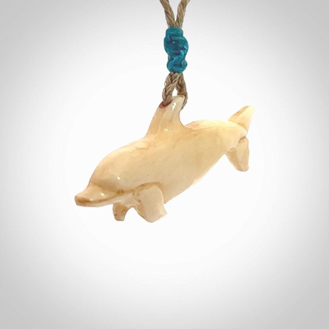 Hand carved dolphin bone pendant. Hand made bone dolphin necklace. Hand crafted bone dolphin pendant. Provided with an adjustable cord.