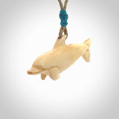 Hand carved dolphin bone pendant. Hand made bone dolphin necklace. Hand crafted bone dolphin pendant. Provided with an adjustable cord.