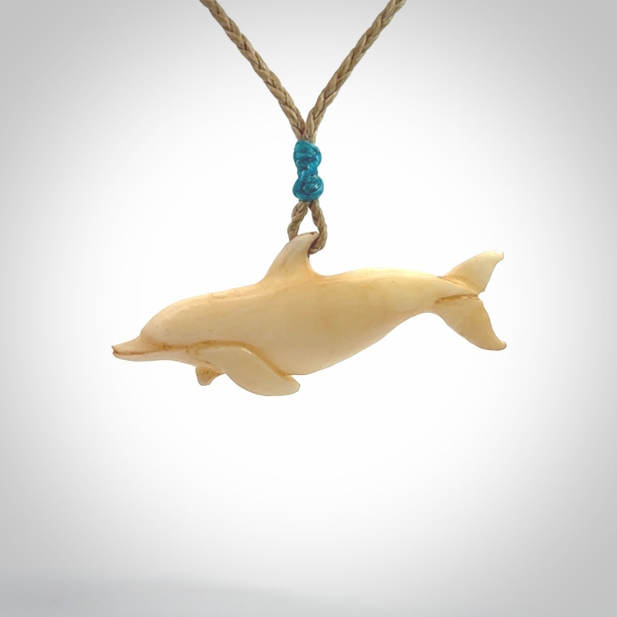Hand carved dolphin bone pendant. Hand made bone dolphin necklace. Hand crafted bone dolphin pendant. Provided with an adjustable cord.