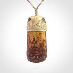 A hand carved bone toki pendant with NZ Pacific logo engraving. These have been stained with our home made tea dye. Unique hand made jewellery from New Zealand Pacific.