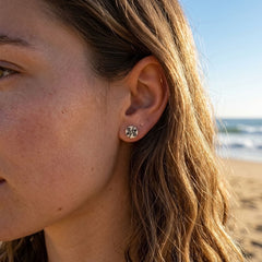 Woman wearing bone stud earrings