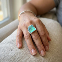Woman wearing paua shell ring