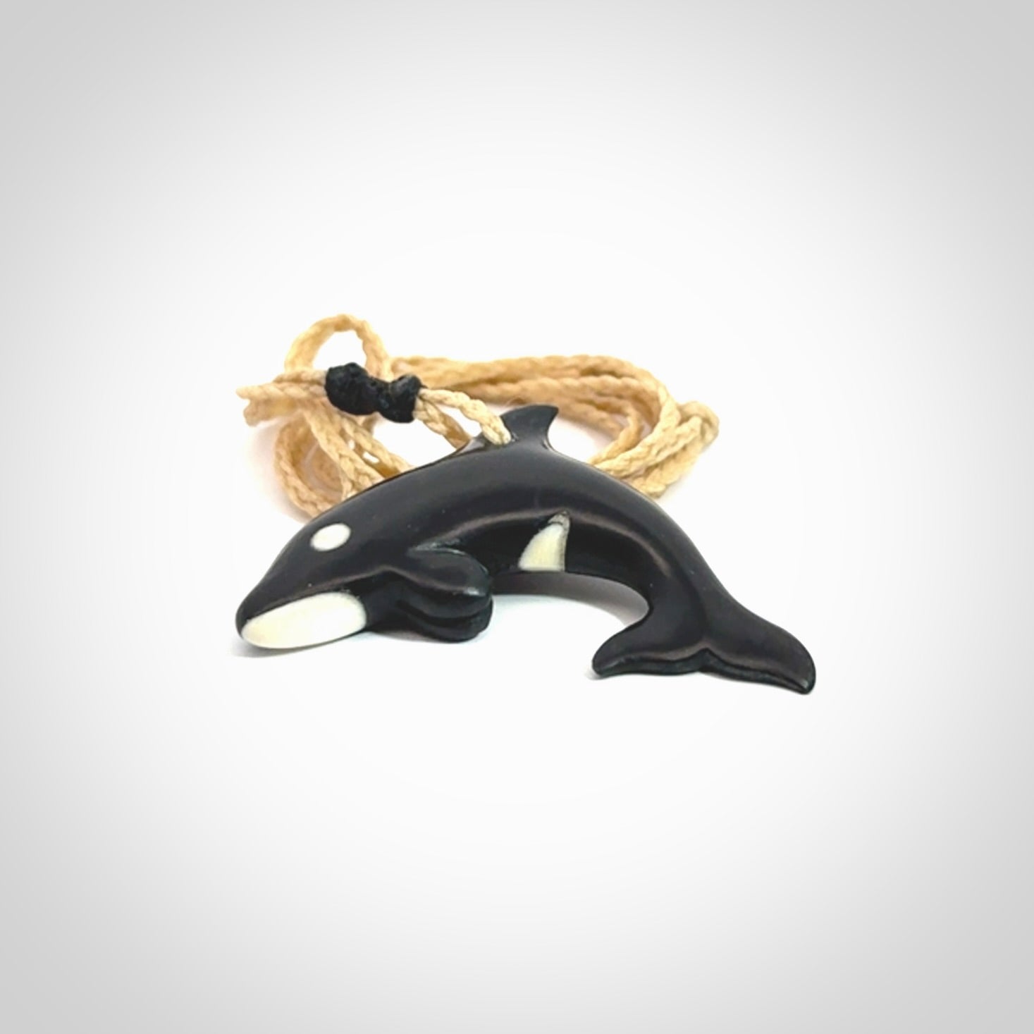 Hand carved black jade and bone Orca pendant. Ocean themed pendants hand carved from natural materials by NZ Pacific. Unique handmade jewellery.