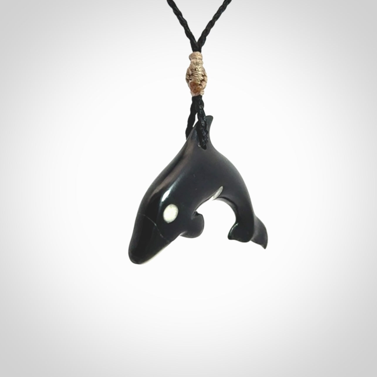 Hand carved black jade and bone Orca pendant. Ocean themed pendants hand carved from natural materials by NZ Pacific. Unique handmade jewellery.