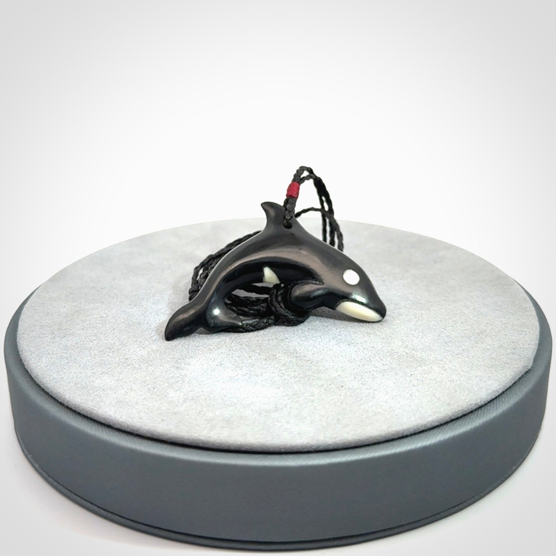 Hand carved black jade and bone Orca pendant. Ocean themed pendants hand carved from natural materials by NZ Pacific. Unique handmade jewellery.