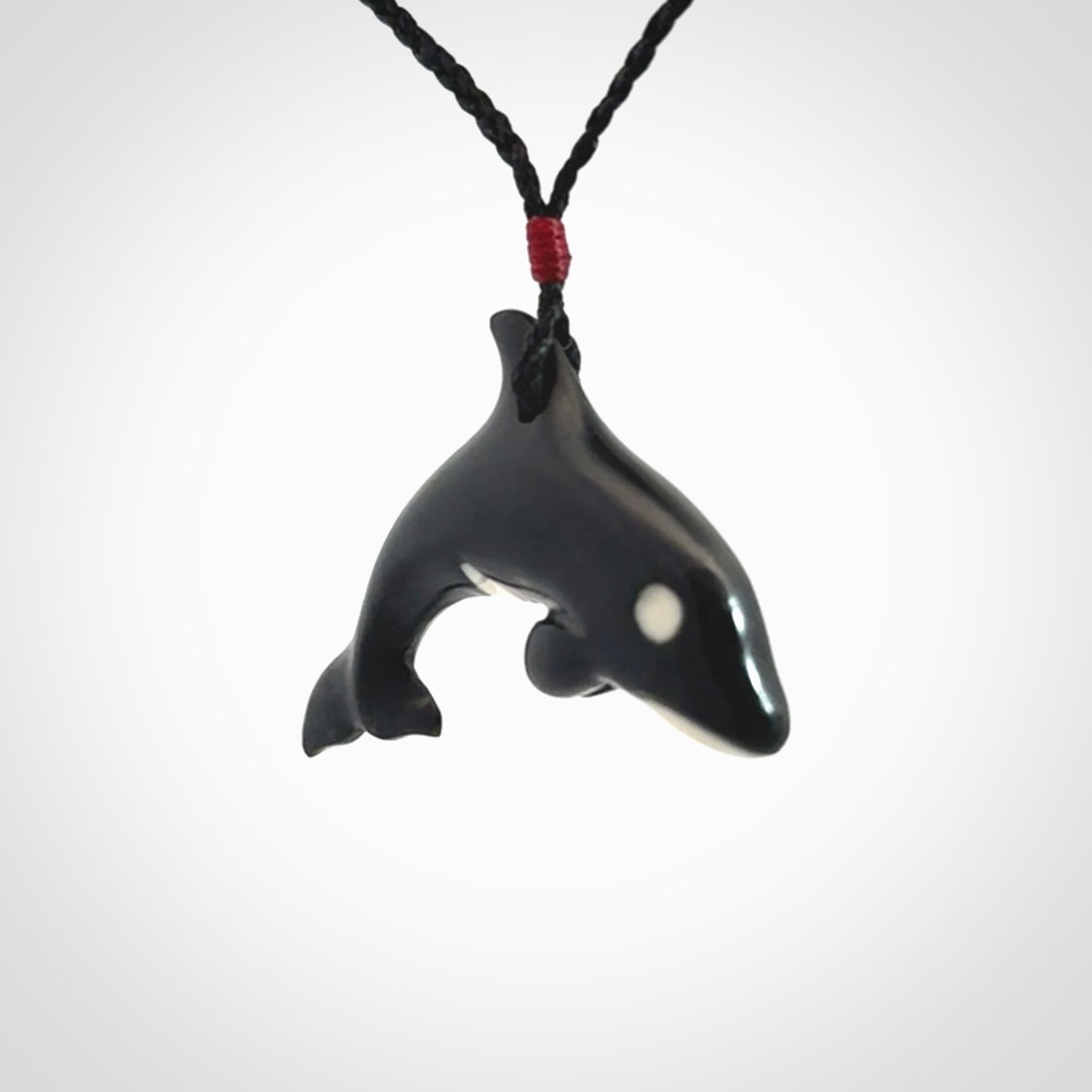 Hand carved black jade and bone Orca pendant. Ocean themed pendants hand carved from natural materials by NZ Pacific. Unique handmade jewellery.